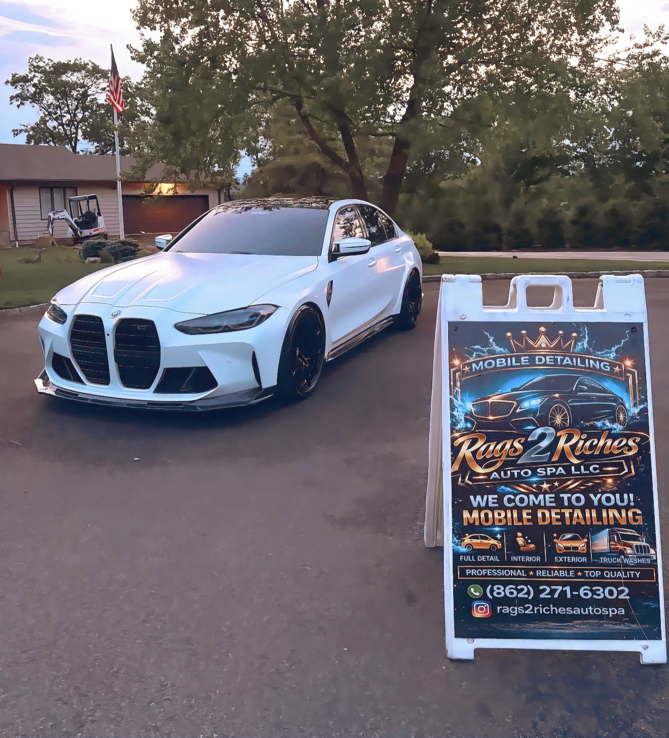 White BMW M3 detailed in a New Jersey driveway at golden hour next to the Rags2Riches mobile detailing sign