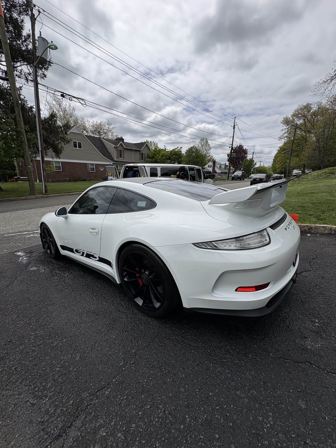 Freshly detailed white Porsche 911 GT3 rear three-quarter view
