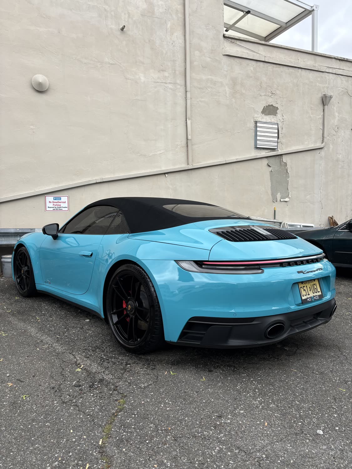 Miami-blue Porsche 911 cabriolet detailed and shining